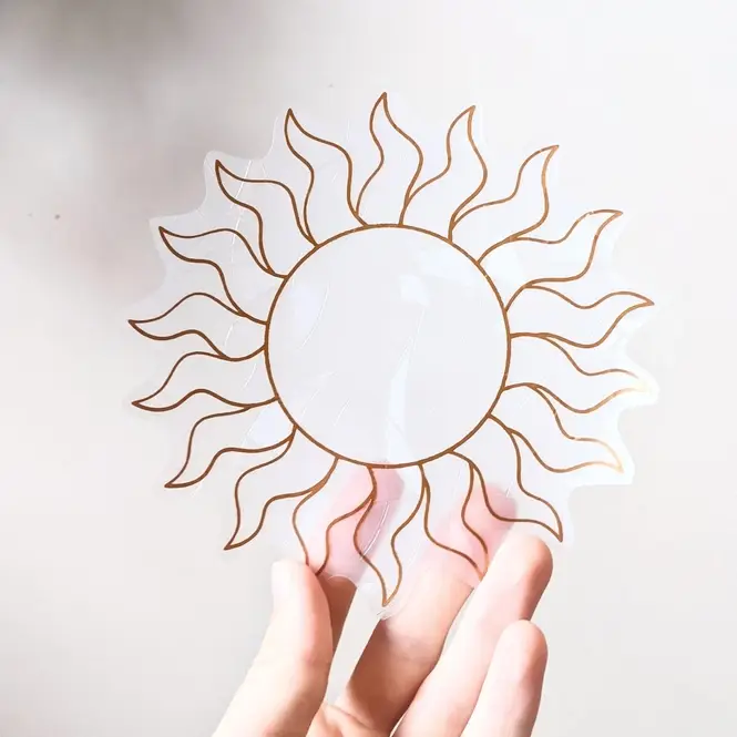 Sticker attrape soleil en forme de de soleil transparent et dorée